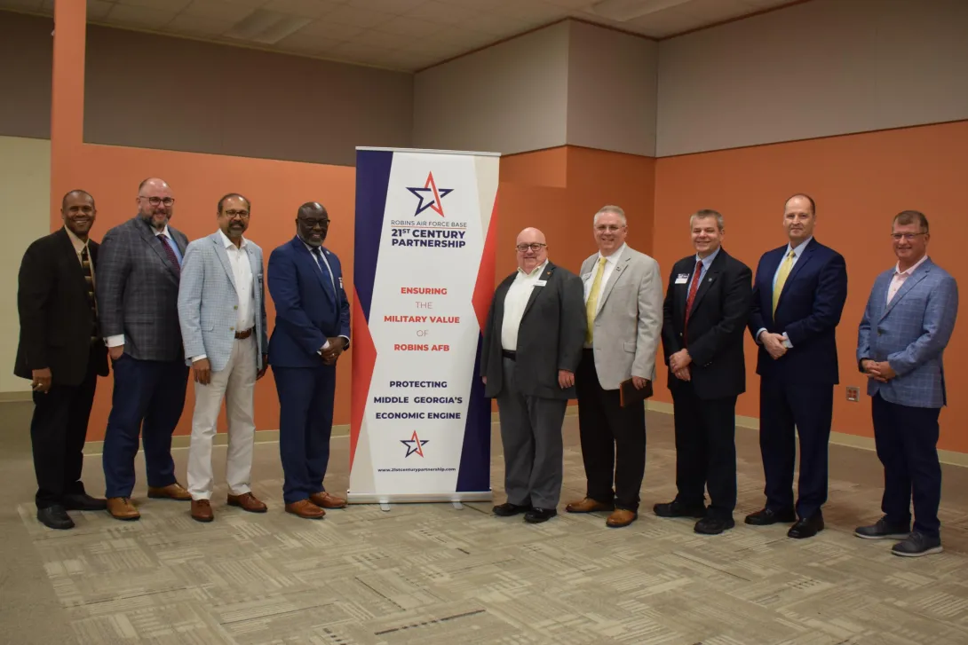 Aaron Stebner, second from left, and Thomas Kurfess, third from right, attending the Robins Regional Chamber’s Eggs and Issues breakfast event on September 8, 2022.