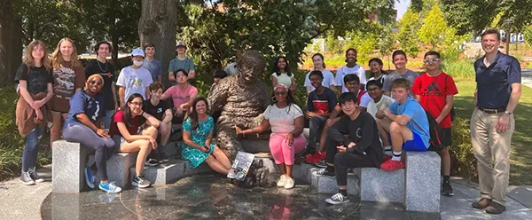Group photo of the participants of the 2022 Energy Unplugged summer camp on the Georgia Tech Atlanta campus staged around the Einstein bench statue/installation.