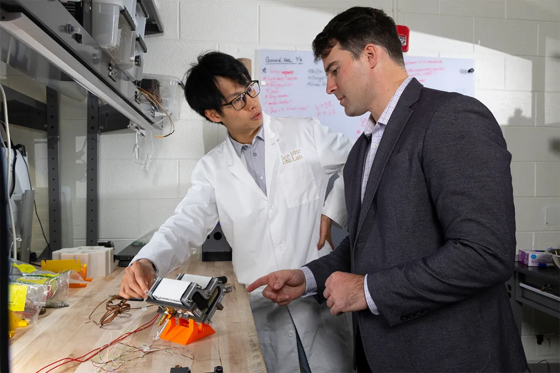Trenton Gantt and Hugh (Ka Yui) Chen work together in the lab