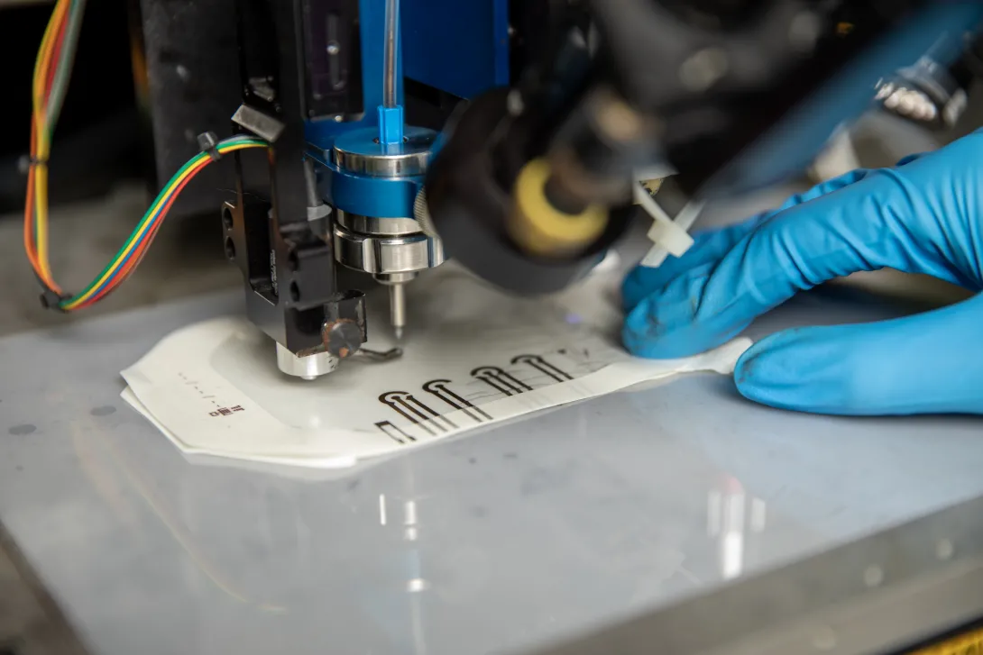 A close-up of the Aerosol Jet printer as it designs a sensor prototype. 