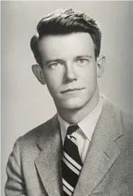 black and white photo of a young man with a serious facial expression. He has short, dark hair, and is wearing a suit and a striped tie.