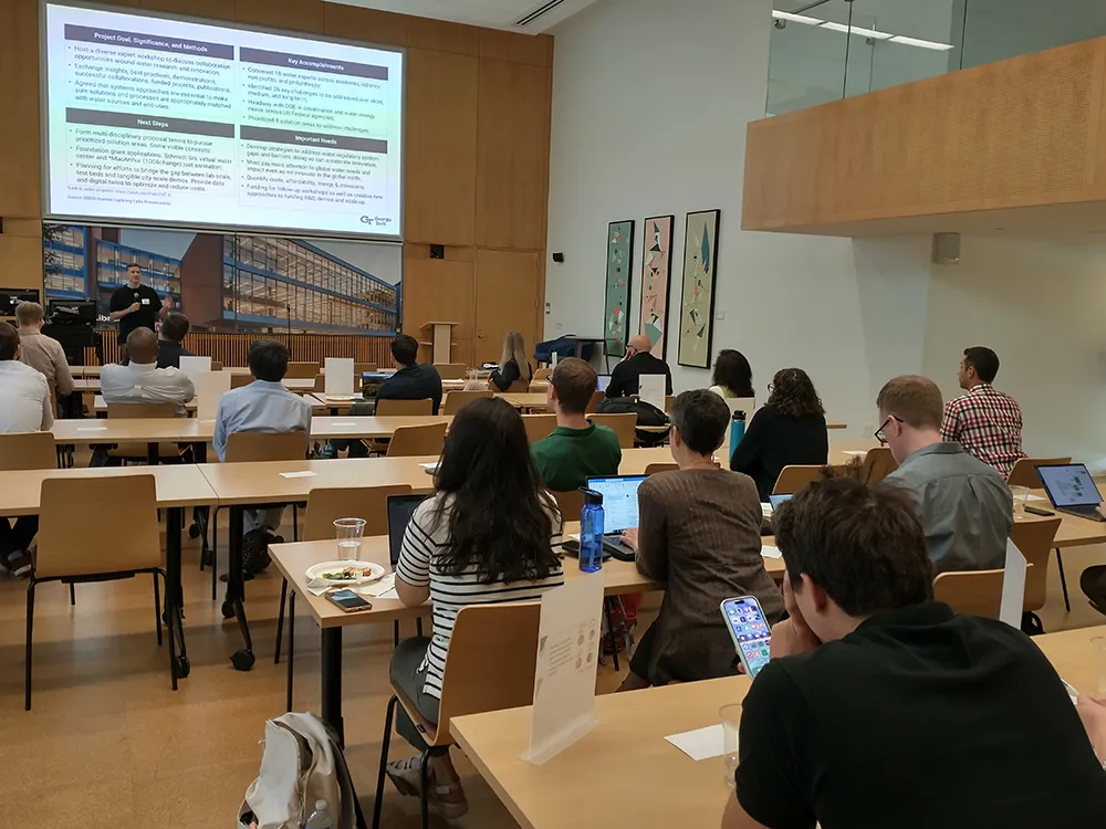 Researchers gather to hear each other's lightning talks.