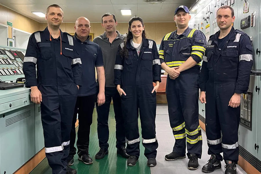 Stathatou (center) onboard the Hedwig Oldendorff vessel with the crew.