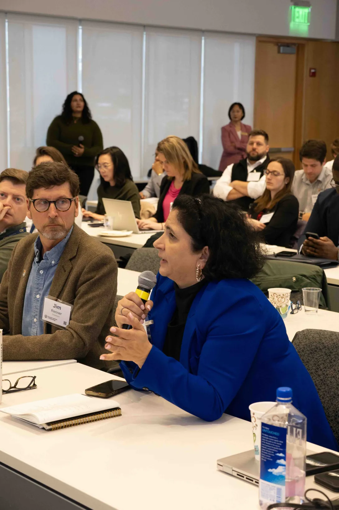Attendee asking a question to the panel at the GEMS-4 Symposium