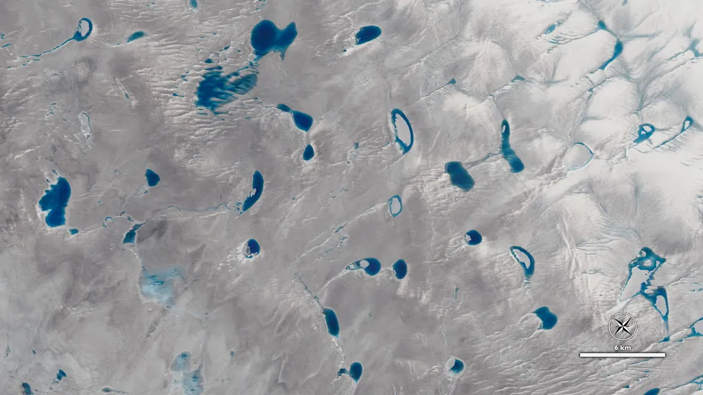 A view of Greenland's ice sheet from the NASA/USGS Landsat 8 satellite showing meltwater lakes on a glacier. (Credit: NASA)