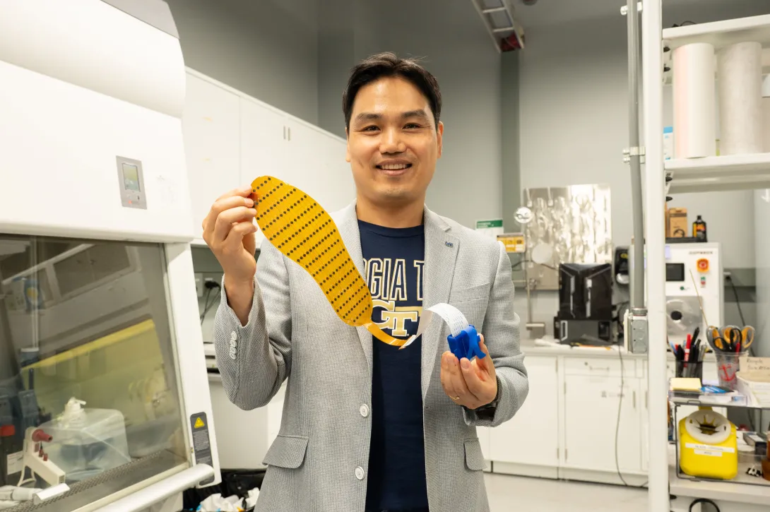 Hong Yeo holds shoe insert.