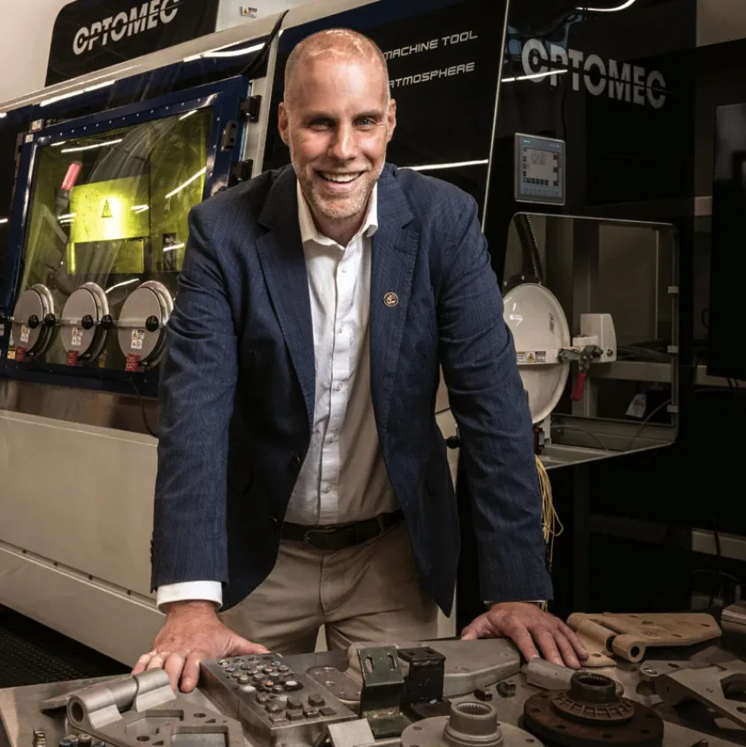 Harnessing Automation: John Morehouse, director of the Georgia Center of Innovation for Manufacturing at the Georgia Department of Economic Development, with a laser cutter at Georgia Tech that produced a variety of parts Photo: Kevin Garrett