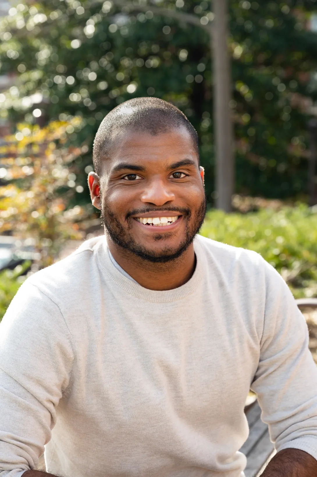 Smiling man sitting outside