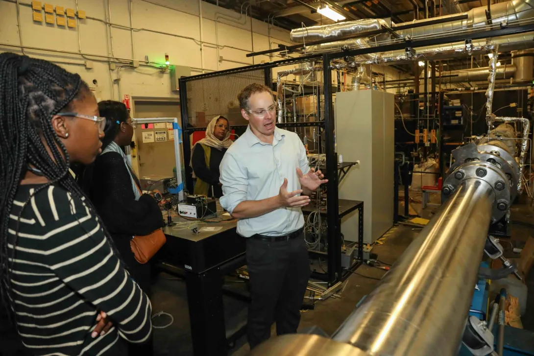 Ben Emerson, Assistant Professor of Aerospace Engineering giving a tour of the Ben T. Zinn Combustion Lab for the Summer Carbon Management Fellows
