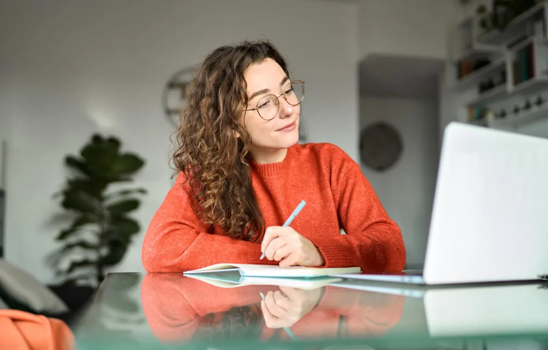 woman taking notes during class 
