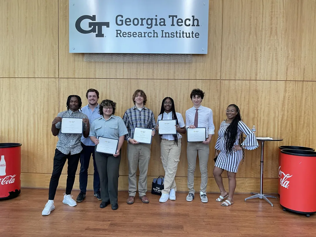High School Students holding their internship completion certificates. Kala Jordan from IPAT pictured far right.