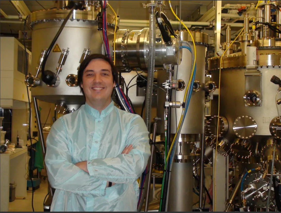 Carver stands in front of JPL’s brand new MBE device, 2009.