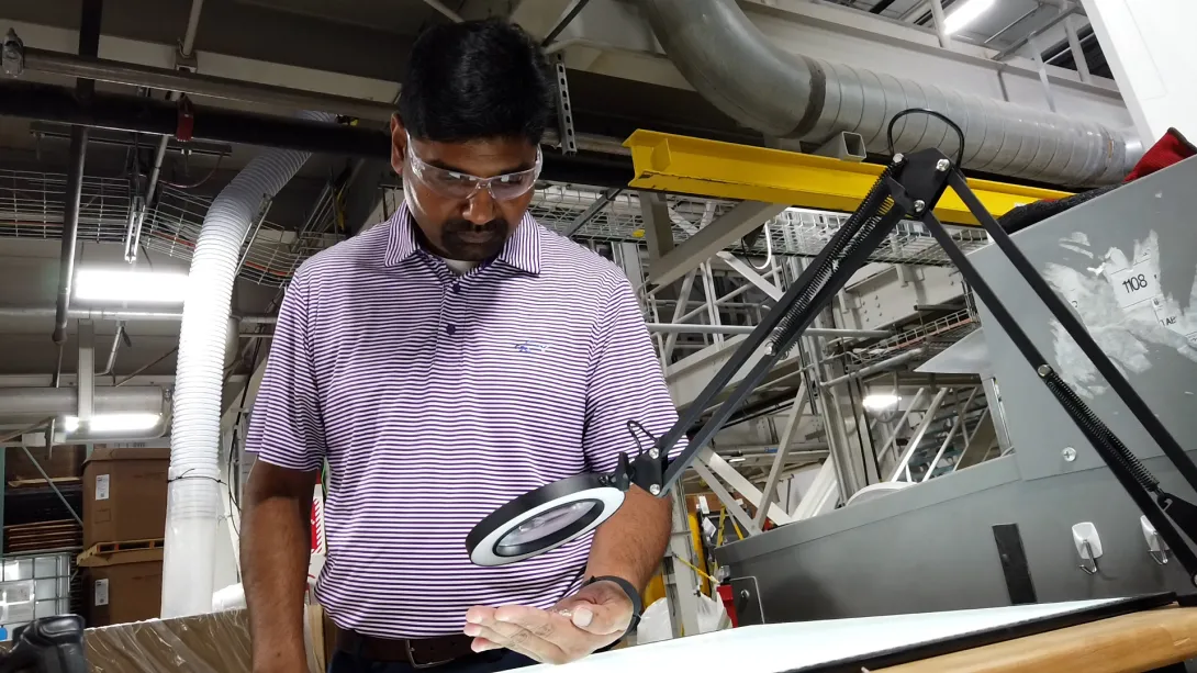 This image shows Sean Madhavaraman, one of the leaders at GaMEP examining work product at Silon in Peachtree City, Georgia.
