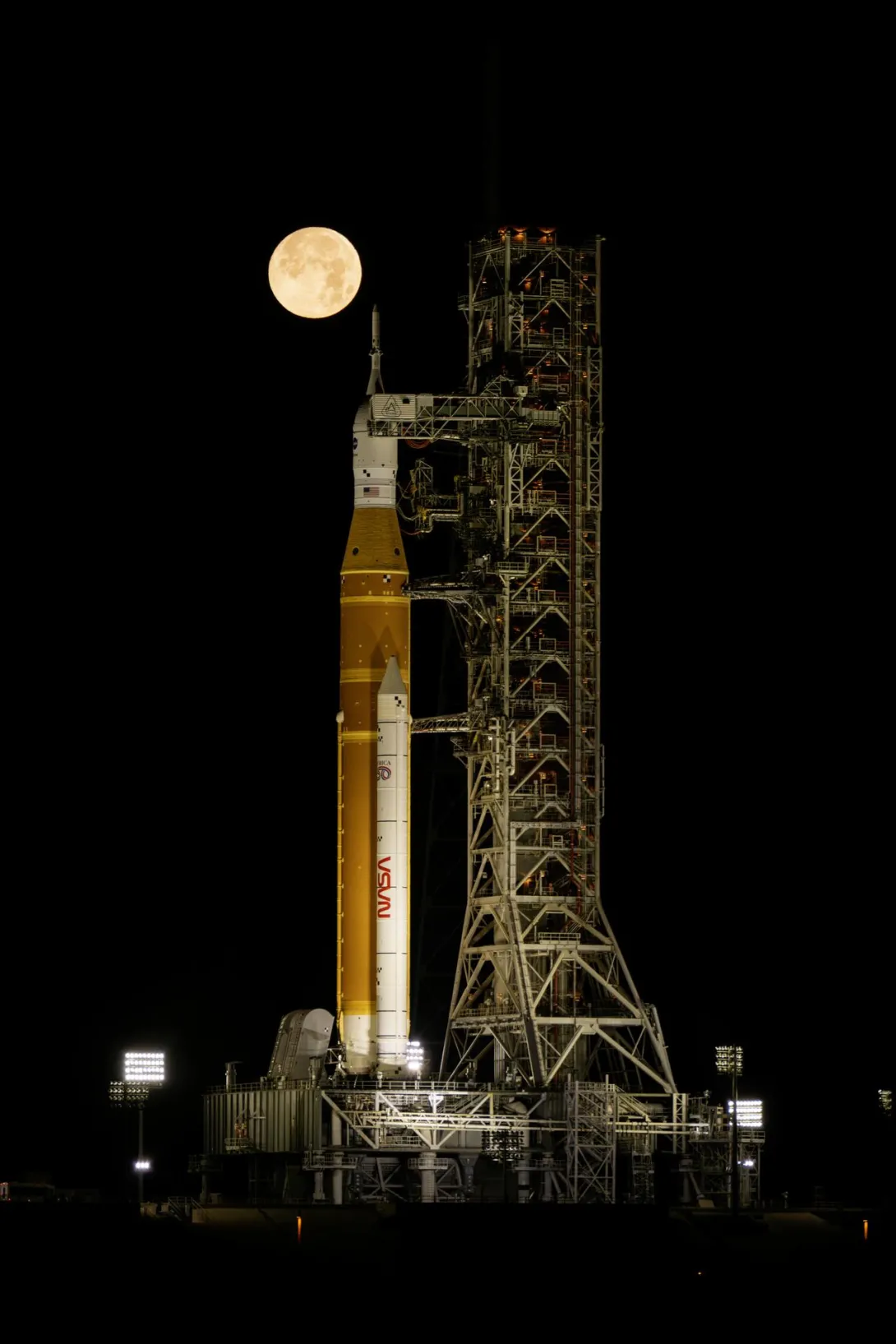 rocket on the launch pad with full moon in background 